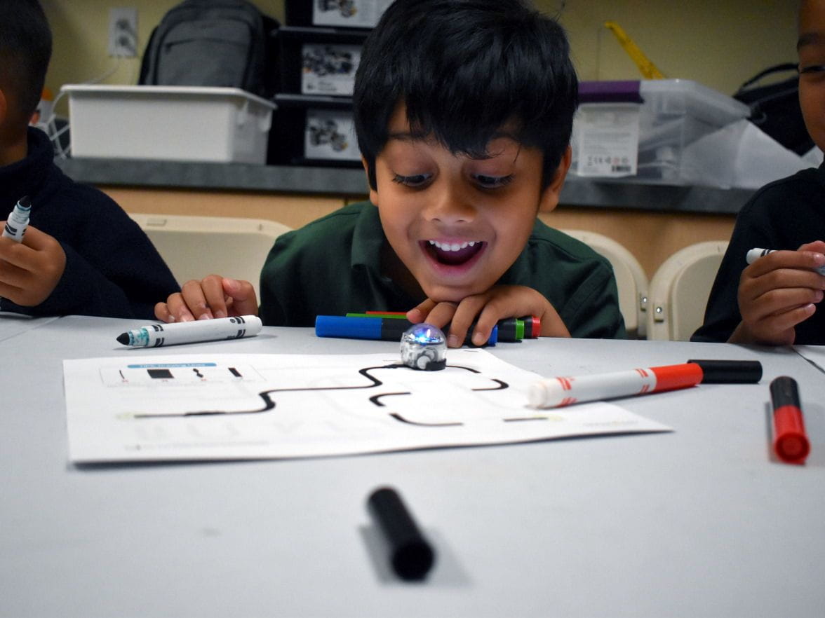 boy learing with a robot